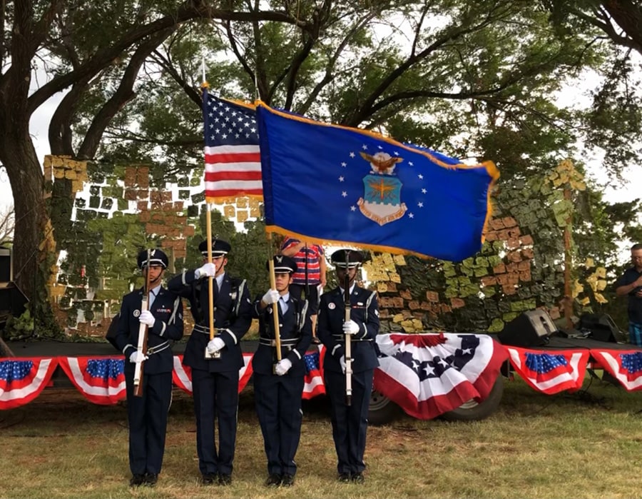 Uniformed men presenting the American and Oklahoma flags at Foss Lake Christmas in July.